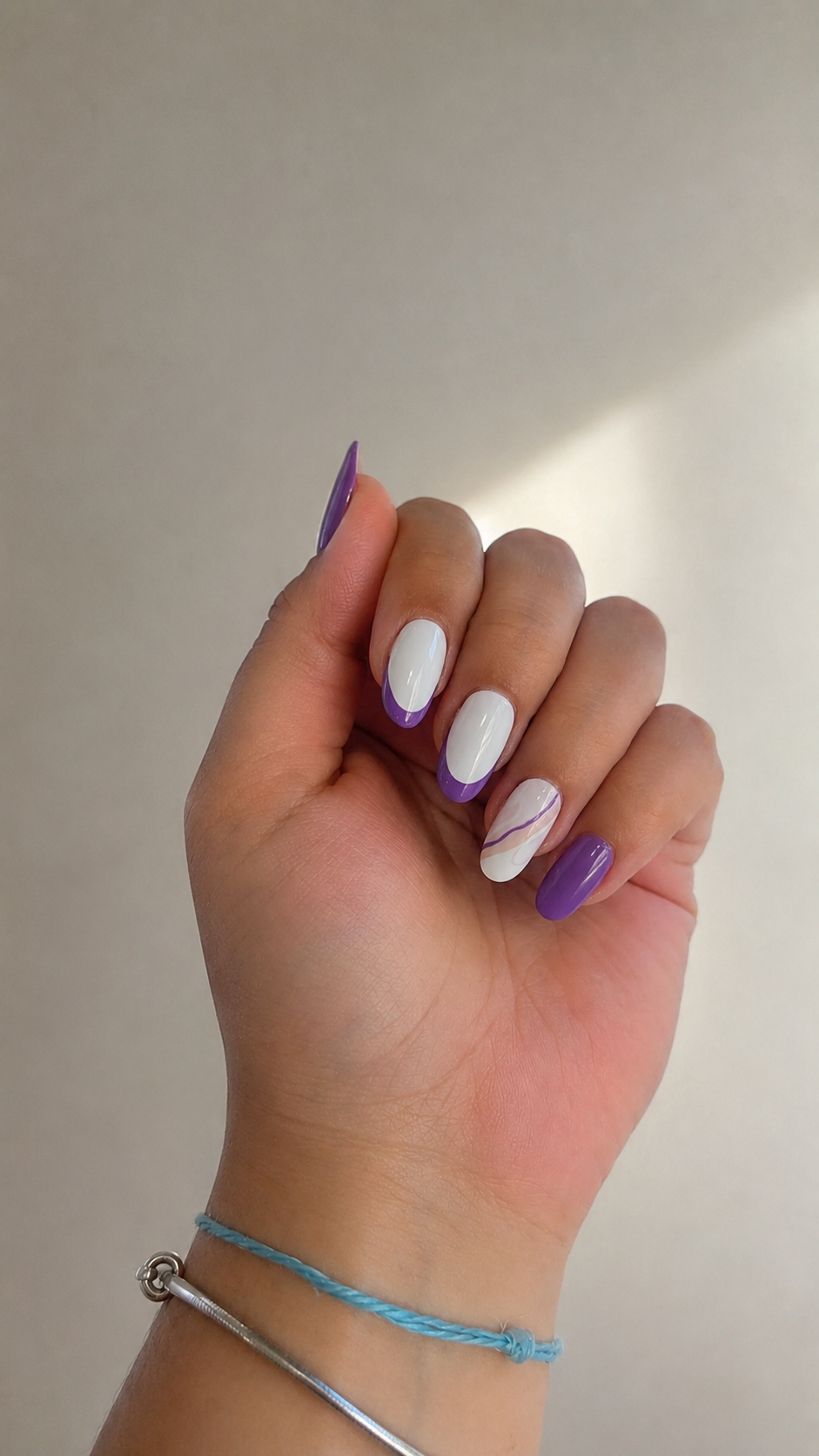 Nail art roxo e branco com detalhe de redemoinho